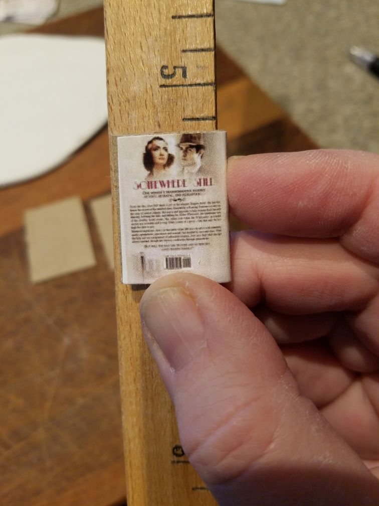 The back cover of a mini book held against a ruler edge