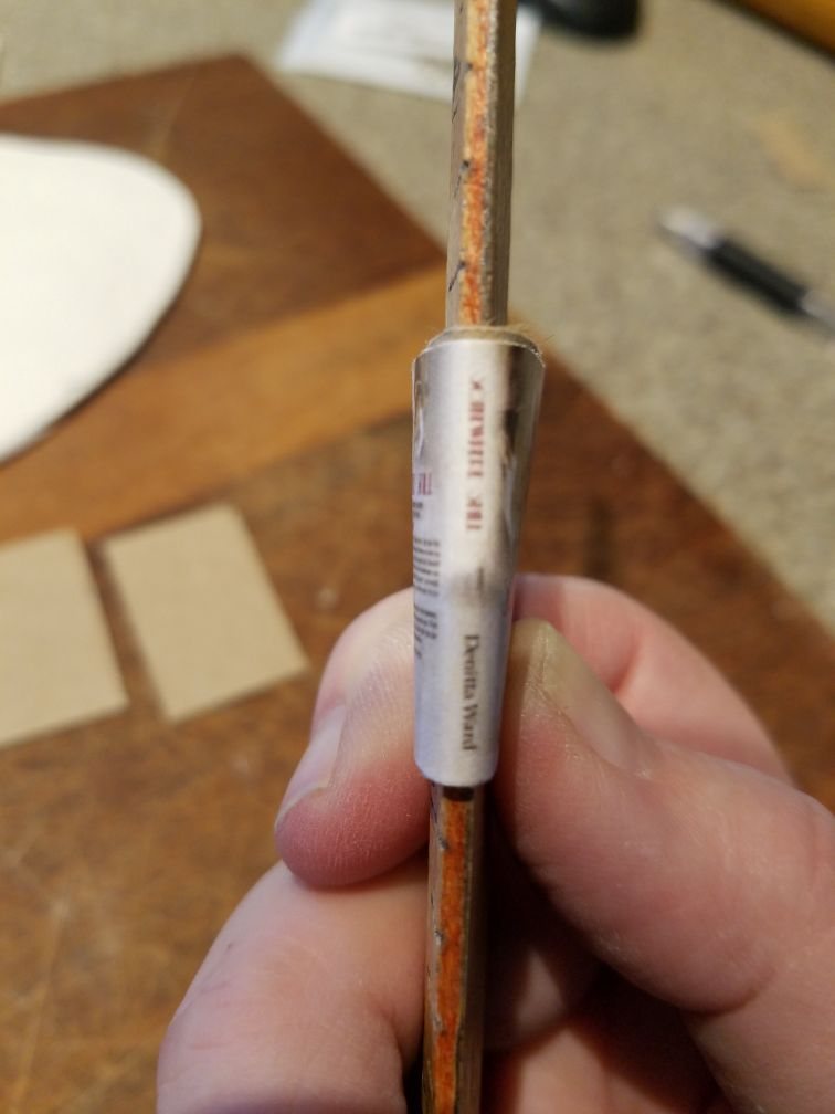 A mini cover wrapped around a thin dowel to shape the spine